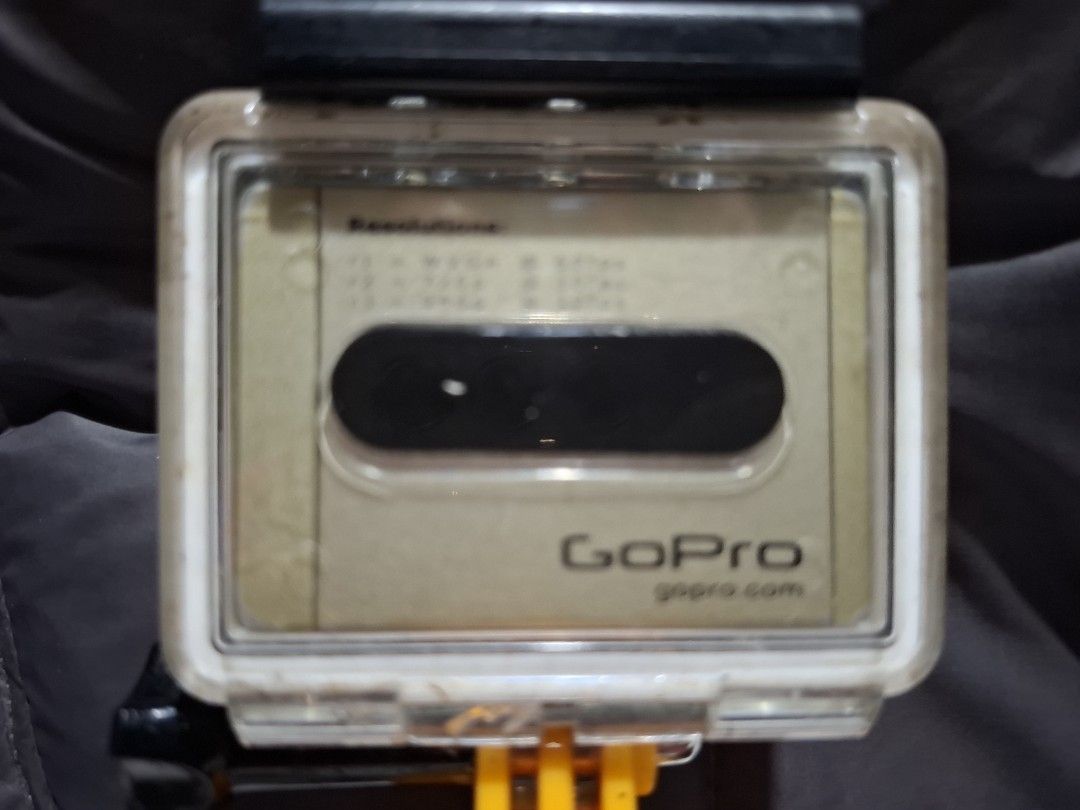 GO PRO ACTION CAMERA (Category: Other Gadgets) located in Carcar. Submitted by brave_brandboss (Listing ID 1449725077, Image 3). Description: GoPro HD HERO (or HD HERO 960) in its standard waterproof polycarbonate housing. Released in the early 2010s, it was one of the brand's first action cameras to shoot high-definition video and features a distinctive gold-colored status LCD front plate. Resolutions: It was capable of shooting up to 1080p at 3