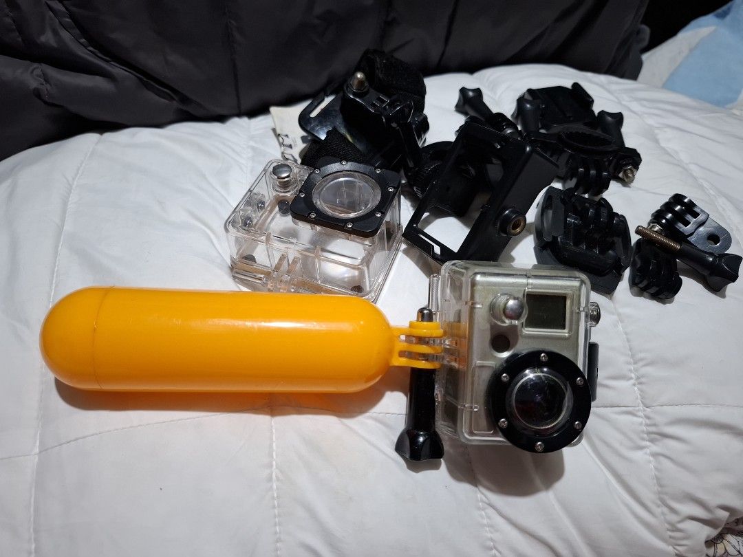 GO PRO ACTION CAMERA (Category: Other Gadgets) located in Carcar. Submitted by brave_brandboss (Listing ID 1449725077, Image 2). Description: GoPro HD HERO (or HD HERO 960) in its standard waterproof polycarbonate housing. Released in the early 2010s, it was one of the brand's first action cameras to shoot high-definition video and features a distinctive gold-colored status LCD front plate. Resolutions: It was capable of shooting up to 1080p at 3