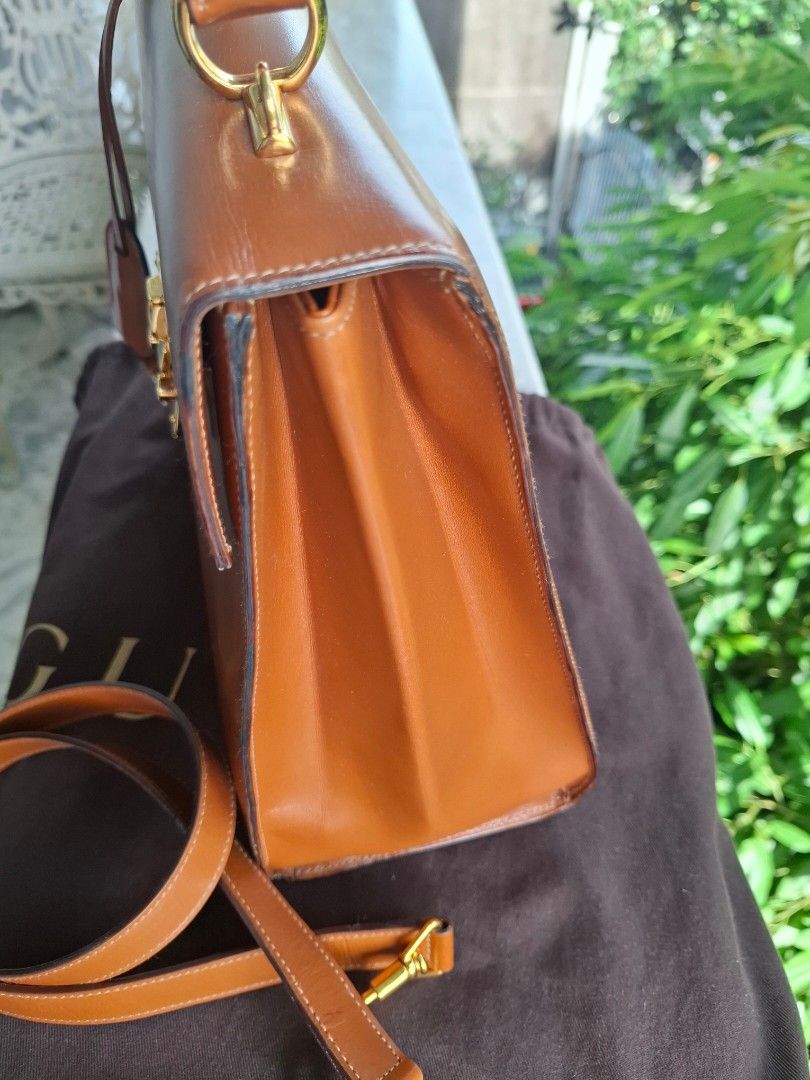 Gucci Brown Leather Top Handle Bag with Strap (Category: Luxury Bags & Wallets) located in Del Monte. Submitted by silvertree_520244 (Listing ID 1449612114, Image 3). Description: - Classic brown leather handbag - Top handle and detachable shoulder strap - Elegant gold hardware details - Interior zippered pocket and slip pocket - Comes with a dust bag.