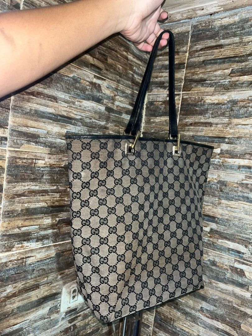 Gucci GG Monogram Canvas Tote Bag (Category: Luxury Bags & Wallets) located in Manila. Submitted by kaloyyyyyy (Listing ID 1449534814, Image 3). Description: - Authentic Gucci tote bag - Classic GG monogram canvas - Black leather trim and handles - Interior zip pocket - Serial number visible in photos - Ideal for everyday essentials.