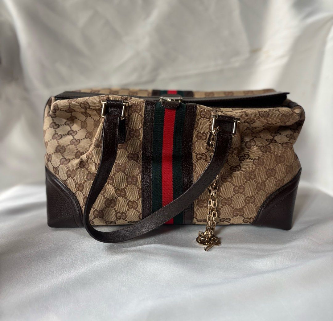Gucci Monogram Canvas Tote Bag with Key Charm (Category: Luxury Bags & Wallets) located in Iloilo. Submitted by iconicangie (Listing ID 1449619692, Image 1). Description: - Beige GG monogram canvas - Dark brown leather trim - Iconic green and red web stripe detail - Detachable key charm and lock included ( lock working / key lose ) - Interior serial number stamp - key lock non working - lock working.