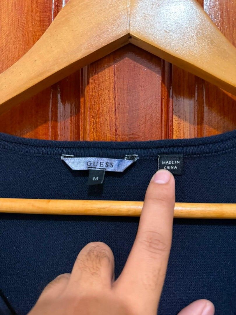 Guess Navy Blue V-Neck Sweater Size M (Category: Coats, Jackets and Outerwear) located in Taguig. Submitted by geestuff27 (Listing ID 1449582240, Image 2). Description: - Navy blue Guess sweater - V-neck style - Guess triangle logo on chest - Size: Medium (M) - Made in China - Versatile: great for layering or wearing on its own.