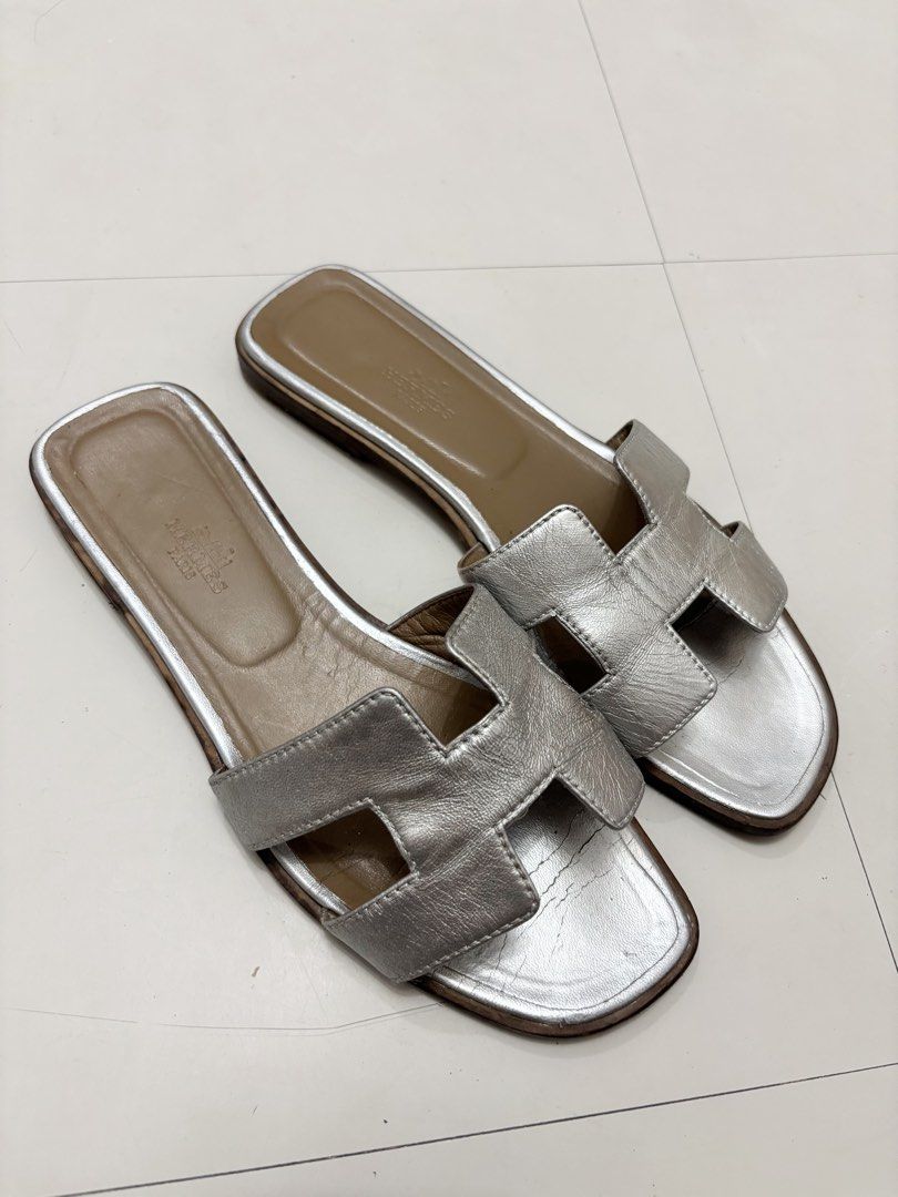 Hermes Silver Oran Sandals (Category: Sneakers & Footwear) located in Makati City. Submitted by bzspr (Listing ID 1449744408, Image 3). Description: Hermes Silver Oran Sandals 100% authentic With dust bag Pair only; no box.