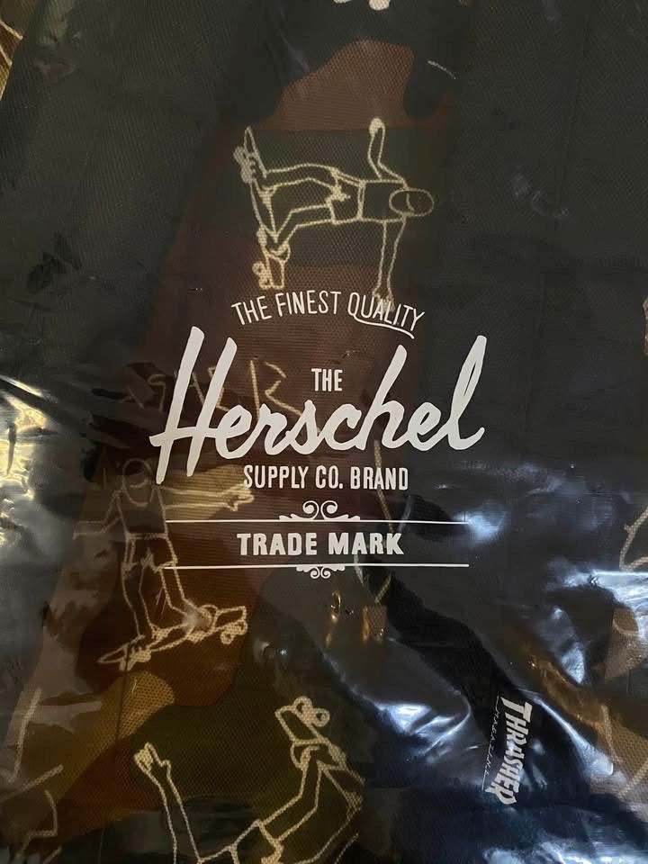 Herschel Supply Co. x Thrasher Backpack (Category: Backpacks) located in Tarlac. Submitted by LStuff (Listing ID 1449663465, Image 3). Description: - Authentic Herschel x Thrasher collaboration backpack. - Unique print featuring skaters performing tricks. - Stylish black base with camouflage detailing. - Ample interior space for all your essentials. - Perfect for school, work, or everyday adventures. - Brand new and still in original packaging. H