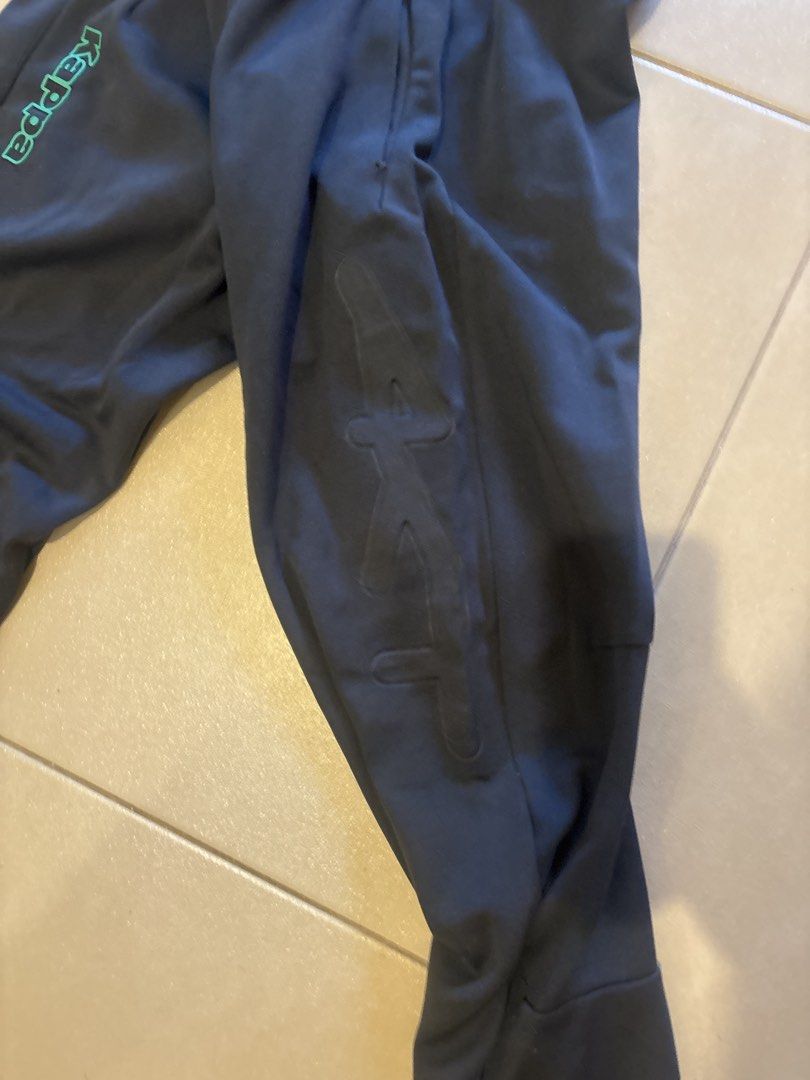 Kappa Navy Blue Track Pants Joggers (Category: Joggers) located in Manila. Submitted by ralphbibera (Listing ID 1449641999, Image 3). Description: - Navy blue Kappa track pants - Green Kappa logo on left leg - Subtle embossed Kappa logo on right leg - Elastic waistband with drawstring - Jogger style with cuffed ankles.