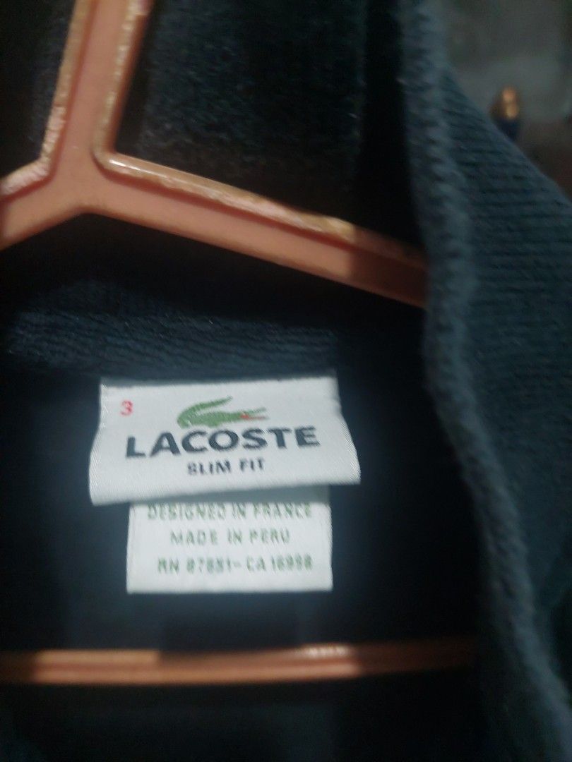 Lacoste Slim Fit Polo Shirt (Category: Tshirts & Polo Shirts ) located in Manila. Submitted by twishi18 (Listing ID 1449647800, Image 2). Description: - Black Lacoste Polo Shirt - Size: 3 - Fit: Slim fit - Features: Blue collar detail with button - Origin: Made in Peru, Designed in France - Style: Ideal for casual wear.