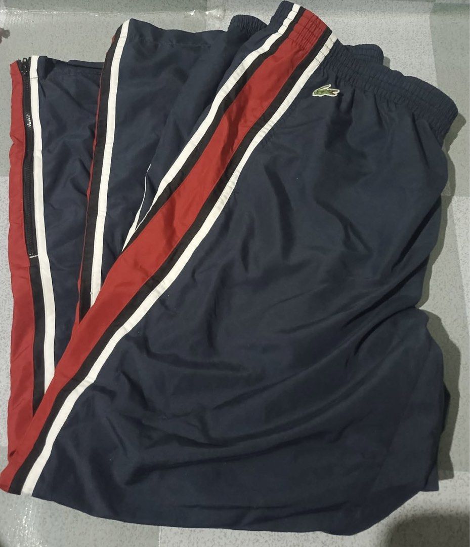 Lacoste Sport Track Pants Navy Red White (Category: Joggers) located in Binangonan. Submitted by sinderella84 (Listing ID 1449534111, Image 2). Description: - Lacoste Sport navy blue track pants - Size 5 - Red and white stripes down the sides - Elastic waistband - Full zip closure on the sides of the legs - Ideal for sports or casual wear.