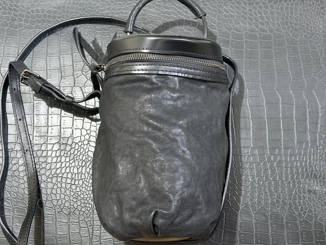 Leather Bag - Lambskin Bucket Bag (Category: Luxury Bags & Wallets) located in Cavite. Submitted by luckygingerivy (Listing ID 1449651431, Image 1). Description: - Soft, black, lambskin leather cylinder bag - Top and bottom lid is made of full grain, smooth cow leather - Features a comfortable top handle made from cow leather - Secure zipper closure on top - Interior zippered pocket for small items - Spacious enough for your phone, wallet, and da