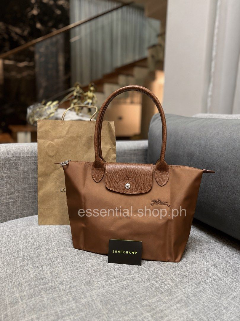 Longchamp Le Pliage Green MLH Cognac (Category: Luxury Bags & Wallets) located in Manila. Submitted by essential.shop.ph (Listing ID 1404263685, Image 1). Description: FOR PRE-ORDER. 1-2 weeks ETA Longchamp Le Pliage Green Medium Long Handle Cognac Includes care card, LGP zip lock pouch and paper bag. Dimensions 28 cm (L - measured at the base of the bag) x 26,5 cm (H) x 15,5 cm (W).