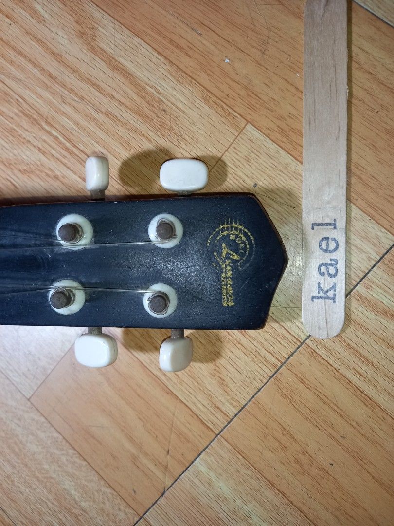Lumanog Tenor Ukulele (Category: Musical Instruments) located in Taguig. Submitted by kaeltiglao (Listing ID 1449597848, Image 3). Description: This is a Noel Lumanog Tenor Ukulele (~69cm /27in) RFS: decluttering and need funds for college Specs: Body: laminated plywood Strings: Last restring was June 2024 (Standard GCEA strings) Note: ❗️There are light scratches all throughout the body and some wood chipping around the seams but it does not affe