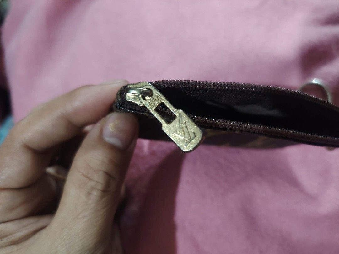 LV coin purse (Category: Luxury Bags & Wallets) located in Malolos. Submitted by shoptokyothrift (Listing ID 1449565634, Image 2). Description: Louis Vuitton Monogram Key Pouch / Coin Purse ✨ Classic Louis Vuitton Monogram coated canvas ✨ Zip-top closure ✨ Silver-tone key chain & hook ✨ Perfect for coins, folded cash, keys, earbuds, or small essentials ✨ Pre-loved condition with normal signs of use.