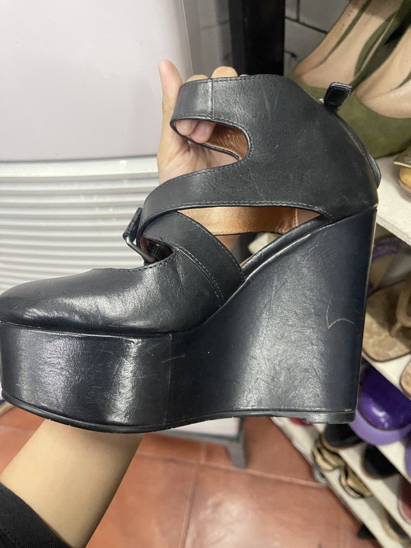Marc by Marc Jacobs Black Leather Platform Wedge Heels (Category: Heels) located in Balanga. Submitted by crowjo (Listing ID 1449701515, Image 2). Description: - Brand: Marc by Marc Jacobs - Color: Black - Material: Leather - Style: Wedge Heels - Features: Criss-cross straps, ankle buckle, chunky platform - Sole: Marc Jacobs logo pattern - Size: 36.