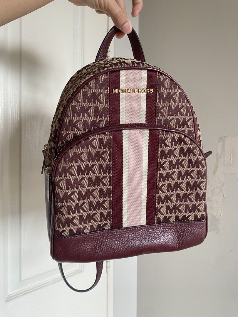 Michael Kors Abbey MD Backpack (Category: Luxury Bags & Wallets) located in Manila. Submitted by jellae (Listing ID 1449625479, Image 1). Description: - Authentic Michael Kors Abbey Backpack - Signature MK print in burgundy and beige - Genuine leather trim - Adjustable straps for comfort - Comes with original tag, with dust bag Used less than 5 times :).