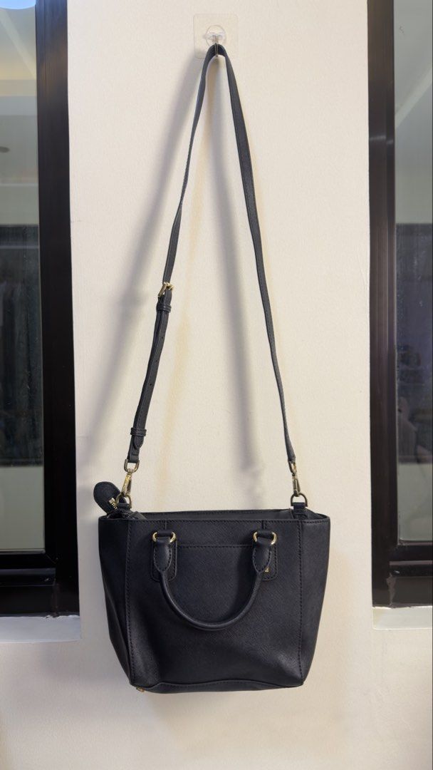 Michael Kors Black Studded Leather Satchel Bag (Category: Cross-body Bags) located in Paranaque City. Submitted by preluxeshop_ph (Listing ID 1449655787, Image 3). Description: Michael Kors Black Studded Leather Satchel Bag - Features elegant gold stud details on front and sides - Includes comfortable top handles - Comes with a detachable crossbody strap for versatile wear - Secure zipper closure - Interior boasts a zip pocket and multiple slip p