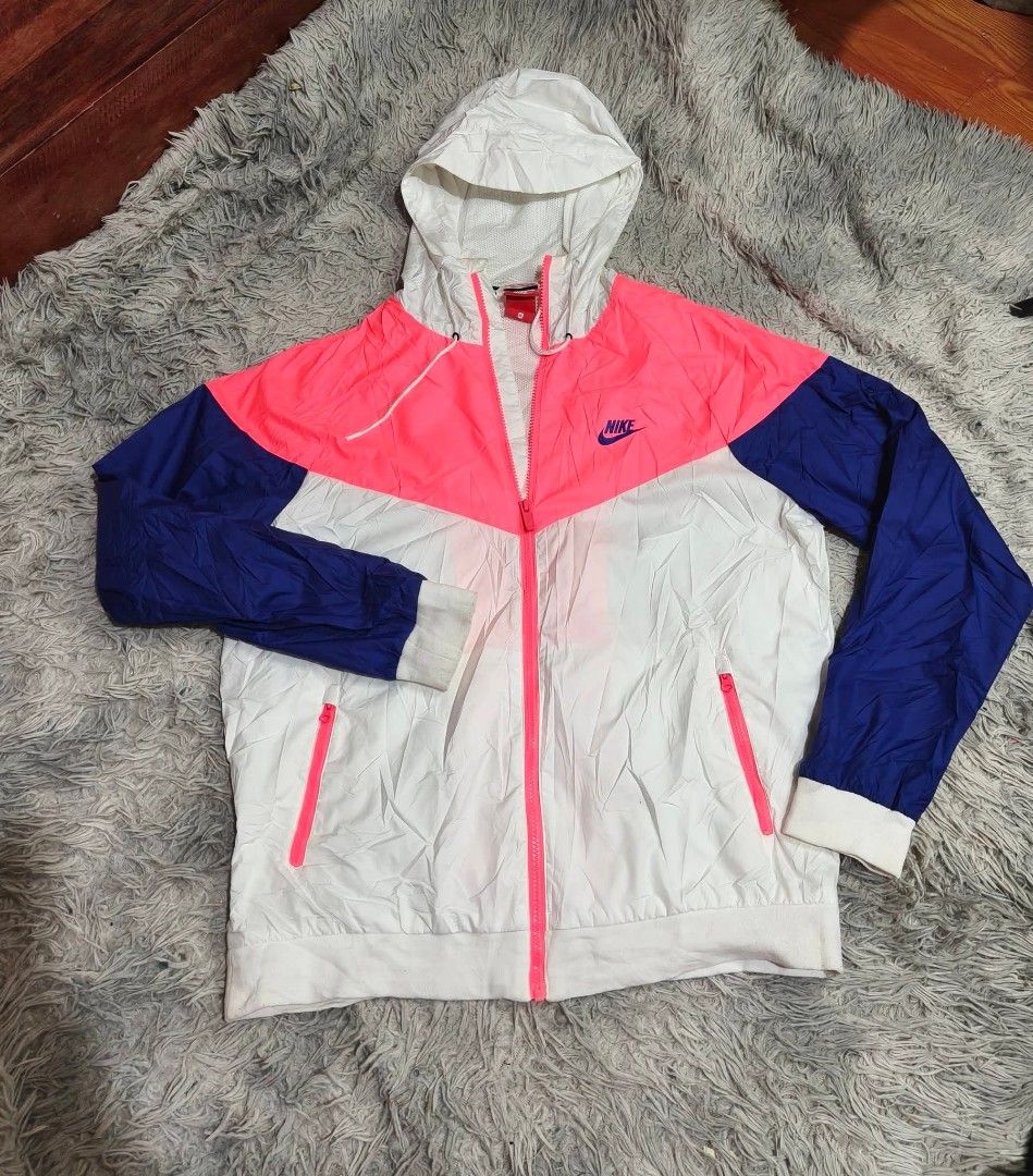 Nike Windbreaker Jacket Colorblock Pink White Blue (Category: Activewear) located in Taguig. Submitted by peterjohn088557 (Listing ID 1449600523, Image 2). Description: - Lightweight Nike windbreaker - Stylish pink, white, and blue colorblock design - Hooded with adjustable drawstrings - Full zip closure - Two convenient zip pockets - Ideal for casual outings or light workouts.