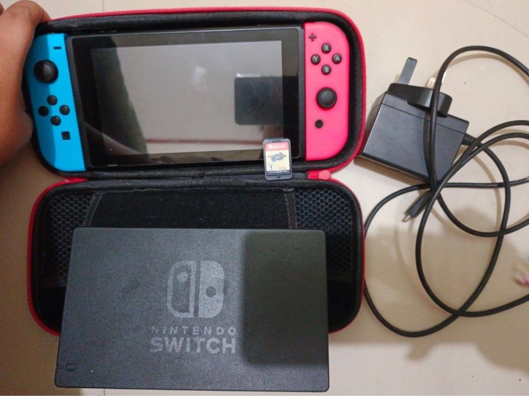 Nintendo Switch Console with accessories (Category: Nintendo) located in Paranaque City. Submitted by _jmsa (Listing ID 1449553602, Image 2). Description: - Nintendo Switch Console - Blue and coral joy-cons (original) - Includes charging cable (original) -comes with its original dock (with HDMI) - Comes with a free carrying case - comes free games! (monster Hunter rise - Ready to play Meet up only‼️ Uptown Mall: Mon- Wed Sm Bicutan: Thurs - Sun .