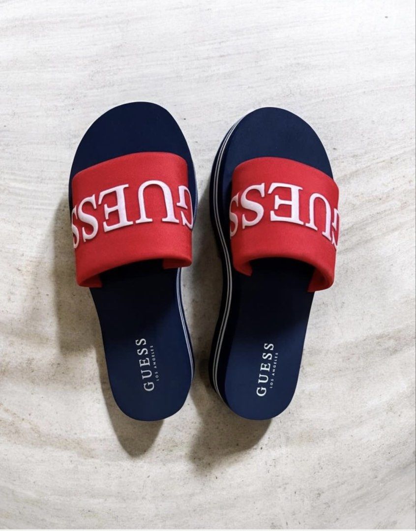 OG Guess Slides Navy Red White Logo Platform Sandals (Category: Slippers and slides) located in Quezon City. Submitted by letsdeclutter101 (Listing ID 1449616059, Image 2). Description: - Navy blue Guess slides - Red strap detail - White Guess logo across the top - Platform sole with white stripe - Comfortable and stylish for everyday wear - Ideal for pool or beach.