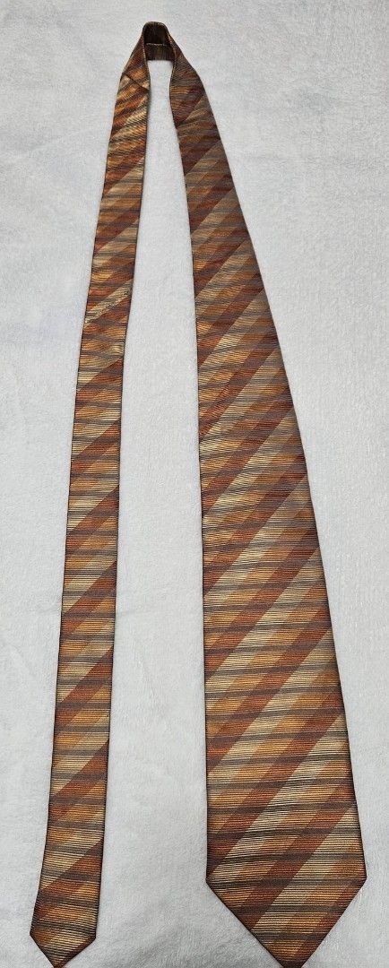 Pierre Cardin Striped Silk Tie (Category: Ties) located in Caloocan City. Submitted by rm.diaz (Listing ID 1449675483, Image 3). Description: - Classic striped tie by Pierre Cardin, Paris - Features brown, orange, and beige stripes. - Made of 100% silk. - Ideal for formal or business occasions. - Adds a stylish pop of color to your outfit..