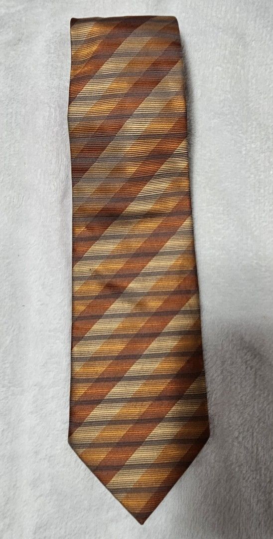 Pierre Cardin Striped Silk Tie (Category: Ties) located in Caloocan City. Submitted by rm.diaz (Listing ID 1449675483, Image 1). Description: - Classic striped tie by Pierre Cardin, Paris - Features brown, orange, and beige stripes. - Made of 100% silk. - Ideal for formal or business occasions. - Adds a stylish pop of color to your outfit..