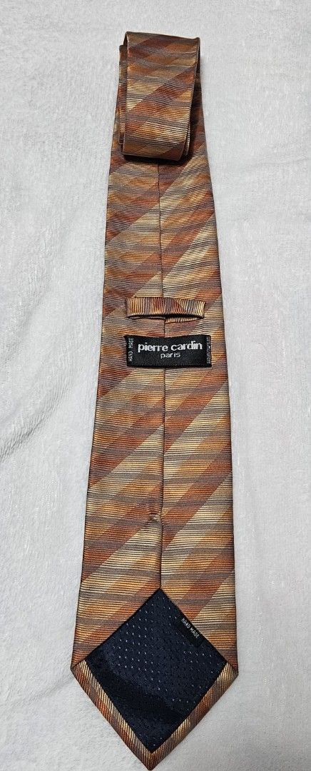 Pierre Cardin Striped Silk Tie (Category: Ties) located in Caloocan City. Submitted by rm.diaz (Listing ID 1449675483, Image 2). Description: - Classic striped tie by Pierre Cardin, Paris - Features brown, orange, and beige stripes. - Made of 100% silk. - Ideal for formal or business occasions. - Adds a stylish pop of color to your outfit..