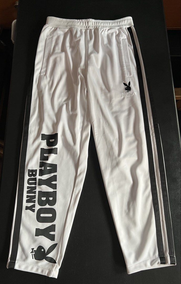 Playboy Bunny White Track Pants Size L (Category: Other Bottoms) located in Makati City. Submitted by annesexy (Listing ID 1449604940, Image 1). Description: - Iconic Playboy Bunny logo and 'PLAYBOY BUNNY' graphic down the leg. - Stylish black stripes along the sides. - Comfortable elastic waistband for a perfect fit. - Ideal for everyday casual wear. - W - 26/32 - L - 35.