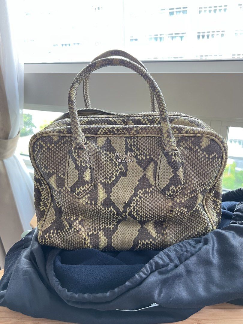 PRADA Python Skin (Category: Bags & Wallets) located in Singapore. Submitted by grace2610 (Listing ID 1449583008, Image 1). Description: 100% Authentic Exotic Python Skin Color : Pistachio Produced in limited quantities Condition : 9/10 (used once or twice) No signs of peeling / Dryness on skin Full Python exterior with full zipper Full calf leather interior - super soft and n pop color (pistachio) With detachable strap Can be carried on shoulder