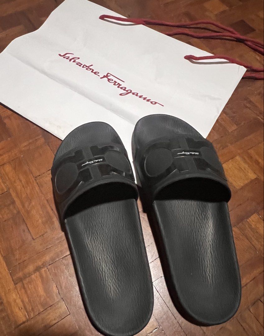 Salvatore Ferragamo Gancini Slides Black (Category: Slippers & Slides) located in Naga. Submitted by emteedee (Listing ID 1449566992, Image 2). Description: - Authentic Salvatore Ferragamo slides - used a few times only, 11.5 inches - Features the iconic Gancini logo - Made in Italy - Comes with paperbag - Ideal for casual wear.
