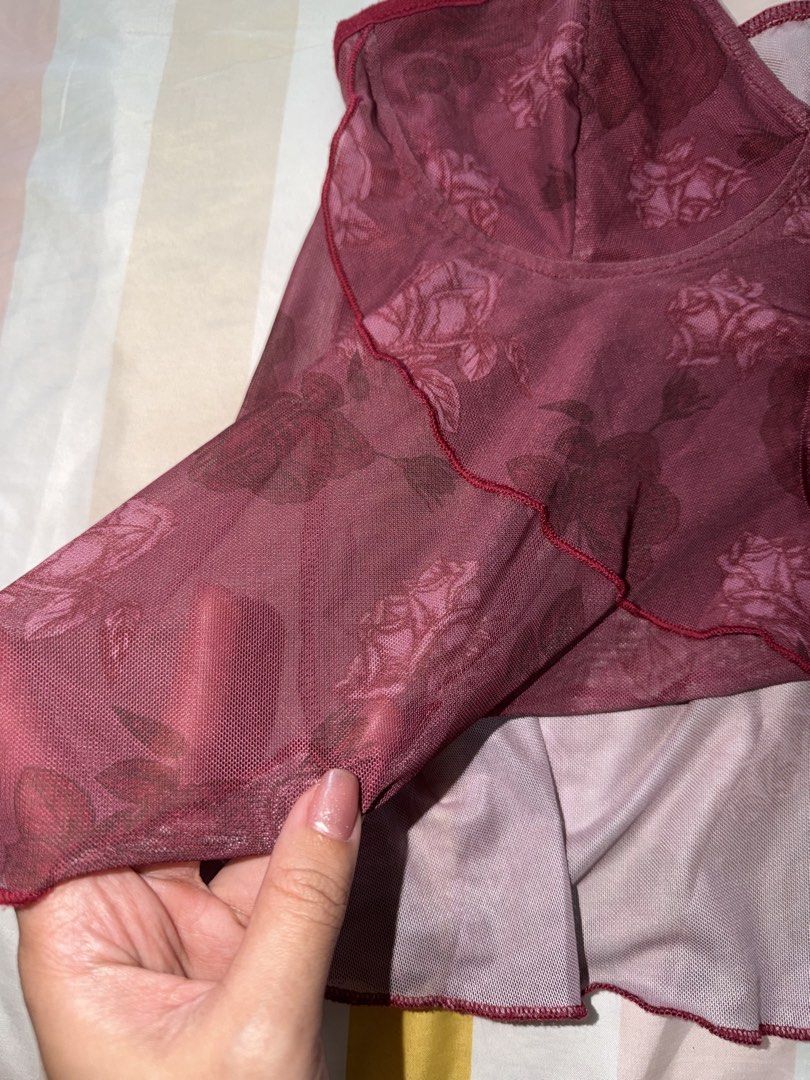 Sheer Rose Print Babydoll Top (Category: Blouses) located in Cainta. Submitted by m4rie_ (Listing ID 1449637869, Image 3). Description: - Burgundy sheer babydoll top - All-over rose print - Adjustable spaghetti straps - Ribbon tie detail at the bust - Ruffled hemline - Lightweight and flowy fabric - Ideal for layering or casual wear RFS: Decluttering Best fits: Medium No defects. Notes: * Items are washed and/or sanitized before shipping. * Color