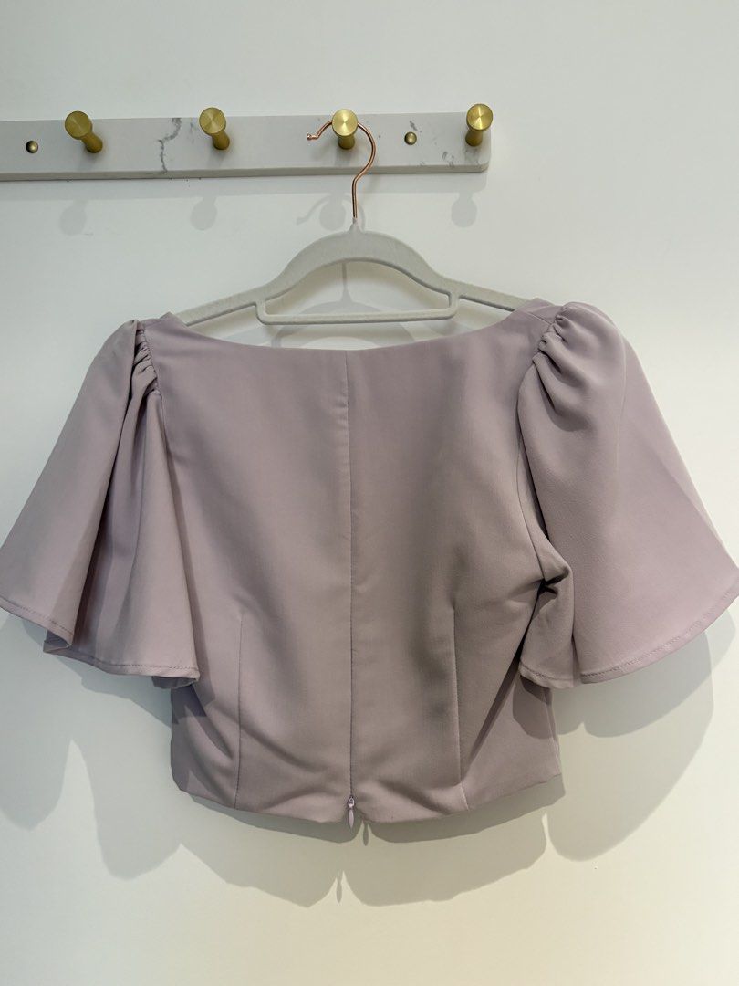 Lovet Lavender Sweetheart Neck Flutter Sleeve Crop Top (Category: Blouses) located in Kuala Lumpur. Submitted by emily.sfl (Listing ID 1449702423, Image 2). Description: - Brand: Lovet - Color: Lavender - Style: Crop top - Neckline: Sweetheart - Sleeves: Flutter sleeves - Closure: Back zipper - Estimated Size: XS - Occasion: Dress up or down.