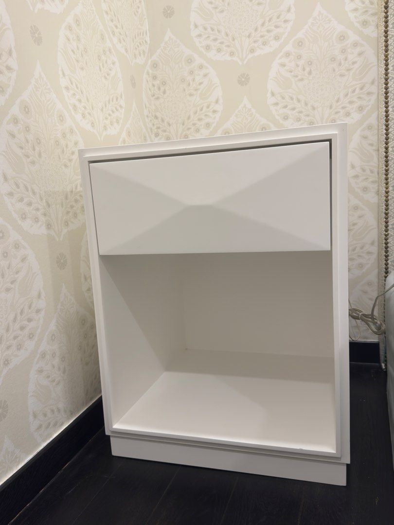 Side table (Category: Shelves, Cabinets & Racks) located in Singapore. Submitted by swifthawk_e22f09 (Listing ID 1449675555, Image 1). Description: - bedside table / night stand - spray painted white - Geometric drawer front, slow closing mechanism - Ample space for essentials - height: 64cm, breadth: 50cm, depth: 50cm (approx measurements) - there is a second piece with some markings available for lower price .