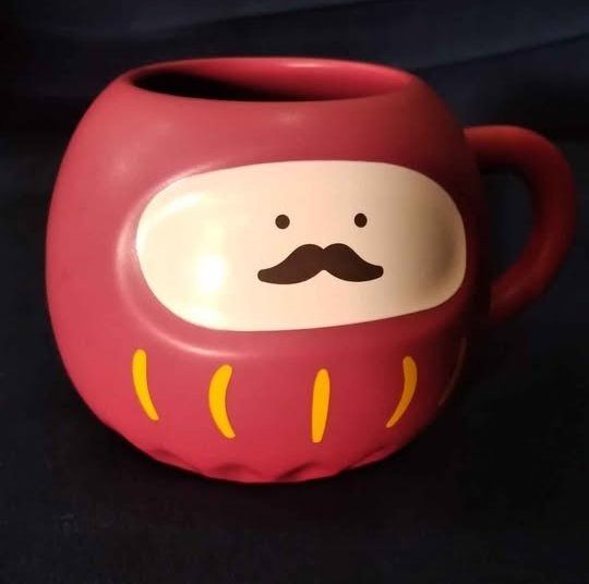 Starbucks Cute Daruma Mug with Mustache (Category: Coffee & Tea Tableware) located in Cainta. Submitted by patrickwilsonstore (Listing ID 1449631125, Image 3). Description: - Adorable Daruma doll shaped mug - Features a cute mustache design - Deep pinkish-red color with yellow accents - Ideal for your morning coffee or tea - Unique and fun design starbucks collectible bnew item only. will provide box when shipping paperbag .