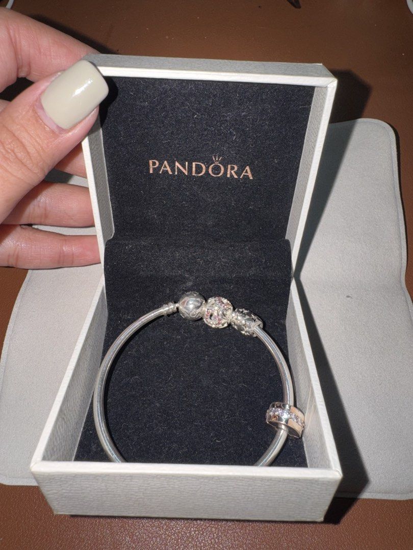 (TAKE ALL) Pandora bracelet with 3 charms (Category: Bracelets) located in Paranaque City. Submitted by nestore.clothing (Listing ID 1449732589, Image 3). Description: - Authentic Pandora sterling silver bangle bracelet - Includes 3 beautiful charms - Star design charm - Cubic zirconia charm - Patterned charm with pink stones Total price of this is around 10k+ .