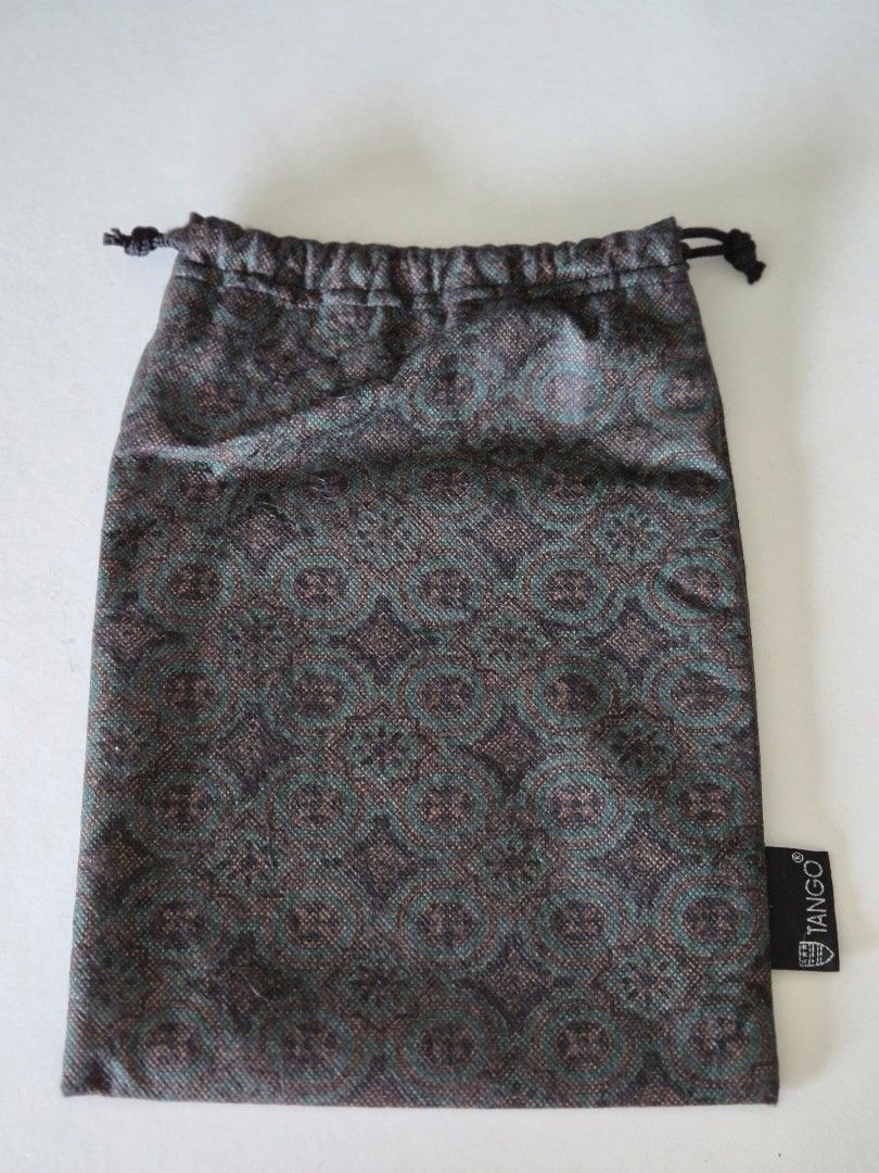 Tango Drawstring Pouch with Pattern (Category: Purses & Pouches) located in Singapore. Submitted by clunar (Listing ID 1449604747, Image 3). Description: - This Tango bag adorned with numerous small white seashells, with a thin silver shoulder strap - Includes a drawstring dark green pattern fabric bag, tag with 'TANGO' logo. - The fabric bag can be use as a drawstring bucket bag or dustbag when storing - Perfect for weekends, casual and stylish 