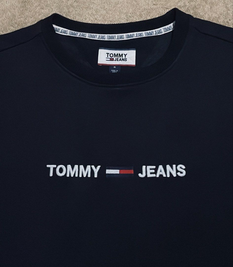 Tommy Jeans Black Sweatshirt Size M (Category: Coats, Jackets and Outerwear) located in Cebu City. Submitted by johnova18 (Listing ID 1449741431, Image 2). Description: Tommy Hilfiger Embroidered logo Black Sweater Authentic ✅ Size: Large( Medium on tag) Width: 22.5 Length: 28 Color rate: 10/10 Pristine condition Good As New 2000 + shipping fee Location: Cebu City.