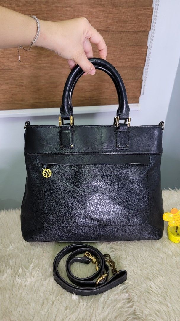 Tory Burch Black Leather Tote Bag with Shoulder Strap (Category: Luxury Bags & Wallets) located in Cavite. Submitted by amairos (Listing ID 1449747966, Image 2). Description: - Genuine black leather Tory Burch tote bag - Elegant gold hardware details - Comfortable top handles - Includes a detachable shoulder strap for versatile carrying - Secure zipper closure to keep your belongings safe - Ample interior space, ideal for everyday essentials or t