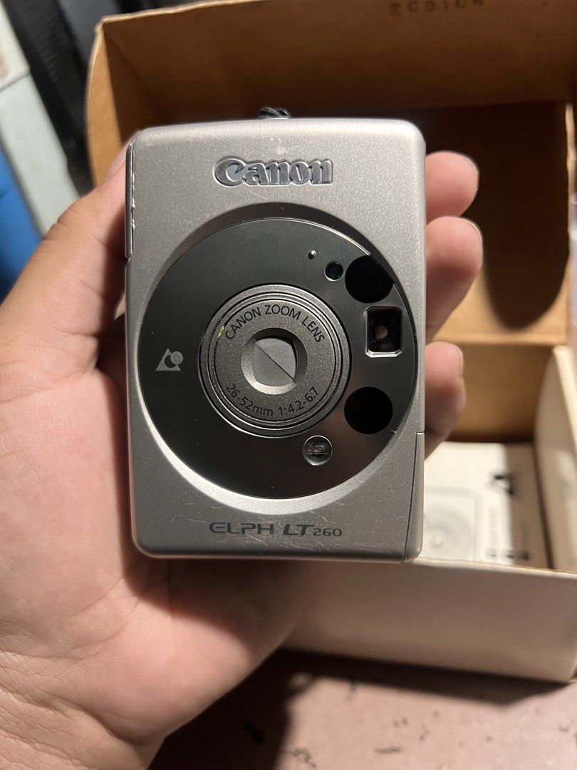 Untested Canon ELPH LT260 Film Camera with Original Box (Category: Cameras) located in Valenzuela. Submitted by pacsjoseph80290 (Listing ID 1449668631, Image 3). Description: - Canon ELPH LT260 film camera - Compact point-and-shoot style - Color: Silver - Includes original box and manual - Ideal for casual photography -Uses APS film Selling as is.