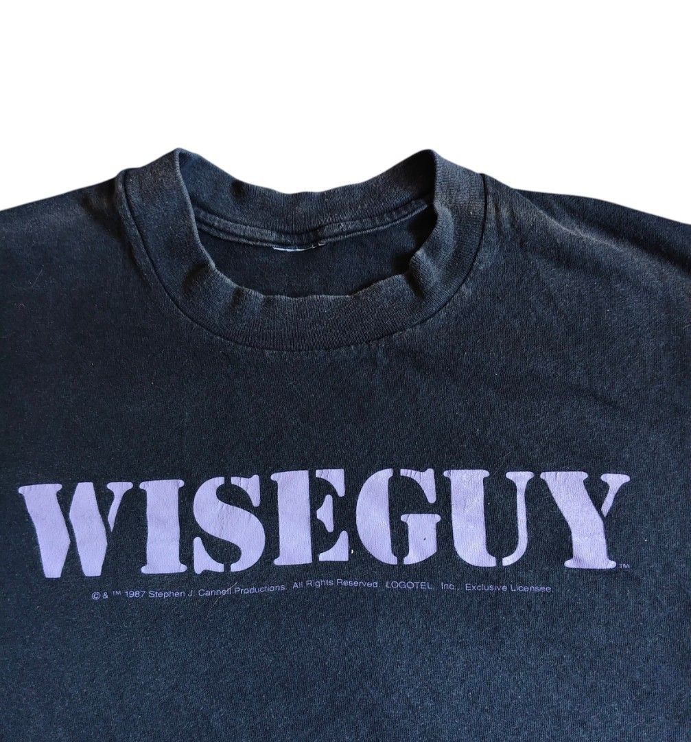 Vintage Wiseguy T-shirt 1987 drama series (Category: Tshirts & Polo Shirts) located in Kuala Lumpur. Submitted by nd_loserkid92 (Listing ID 1449611812, Image 2). Description: - Vintage Wiseguy t-shirt from 1987 - Features the iconic Wiseguy logo in purple - Copyright: Stephen J. Cannell Productions 1987 - Small hole on the front (refer to the last photo for details) - Ideal for fans of the Wiseguy TV show pit 23 labuh 29 single stitch and double 