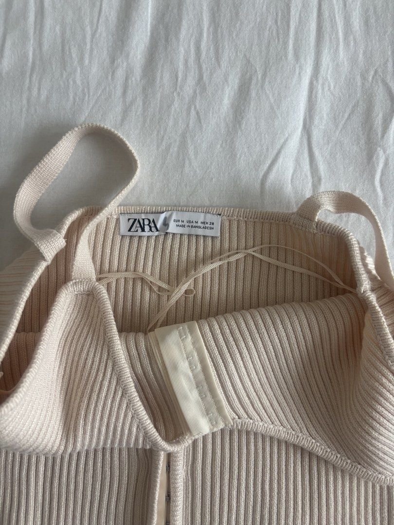 Zara Ribbed Hook Front Tank Top Cream Size M (Category: Sleeveless) located in Paranaque City. Submitted by preloved_archives (Listing ID 1449593925, Image 2). Description: Zara cream ribbed tank top with hook and eye front closure. Adjustable straps. Fits like a Medium. Perfect for layering or solo wear..
