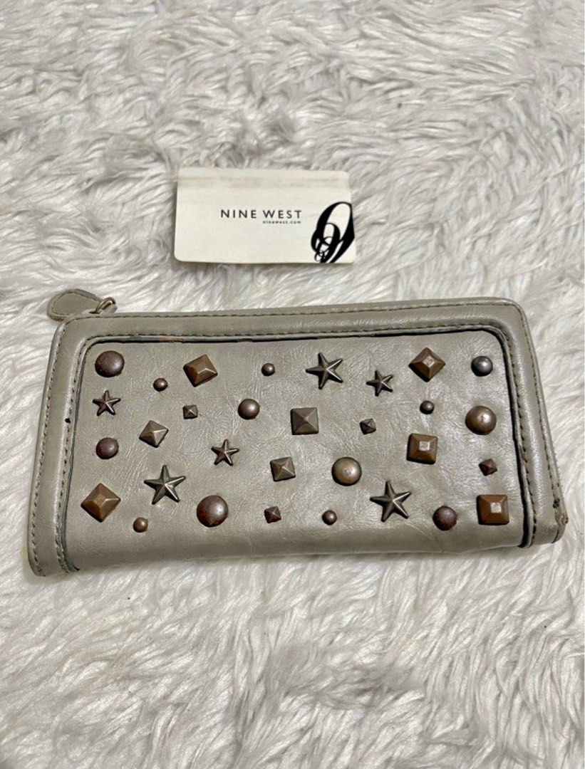 A-026 Nine West Grey Studded Zip Around Wallet (Category: Wallets & Card holders) located in Bayambang. Submitted by foursiblings081228 (Listing ID 1449838785, Image 1). Description: - Grey Nine West wallet - Features star and stud details - Zip around closure for security - Multiple interior card slots and compartments - Plenty of life left, still very functional.