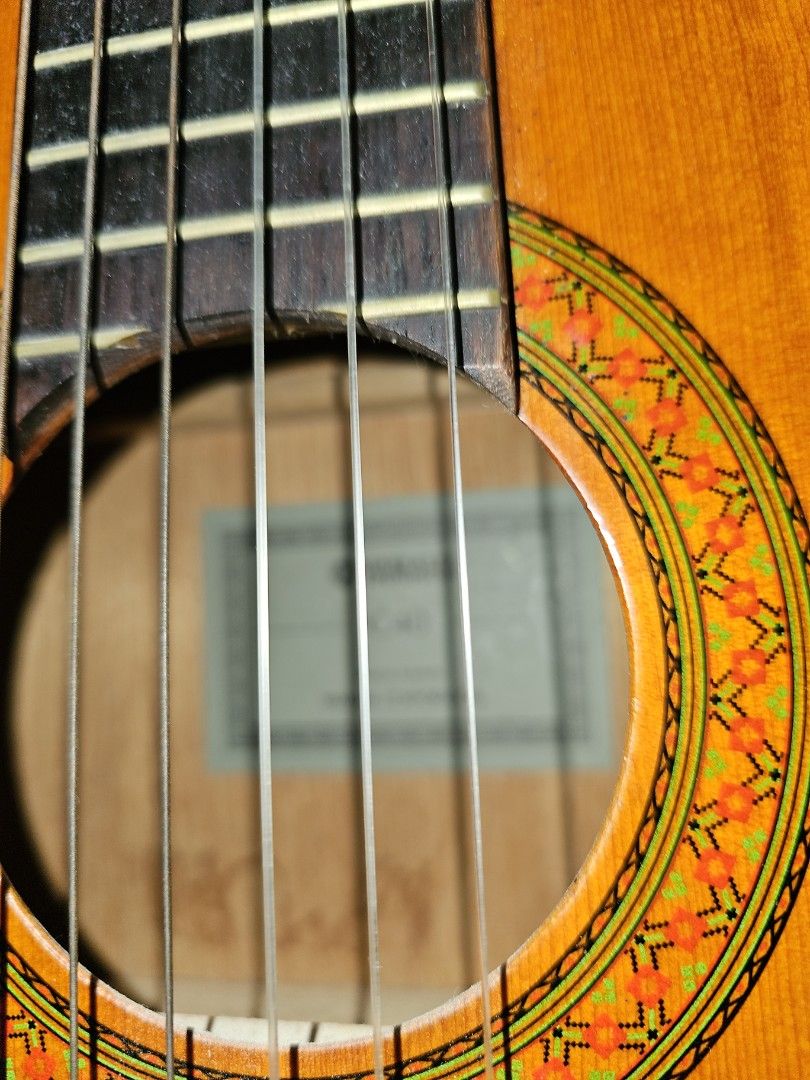 Acoustic Guitar Yamaha C40 (Category: Musical Instruments) located in Manila. Submitted by DANAANFAM (Listing ID 1449767096, Image 2). Description: - Classic acoustic guitar - Warm, rich wood tone - Smooth, easy-to-play fretboard - Suitable for beginners and experienced players - Comes with an attached capo - Ready for its new owner.