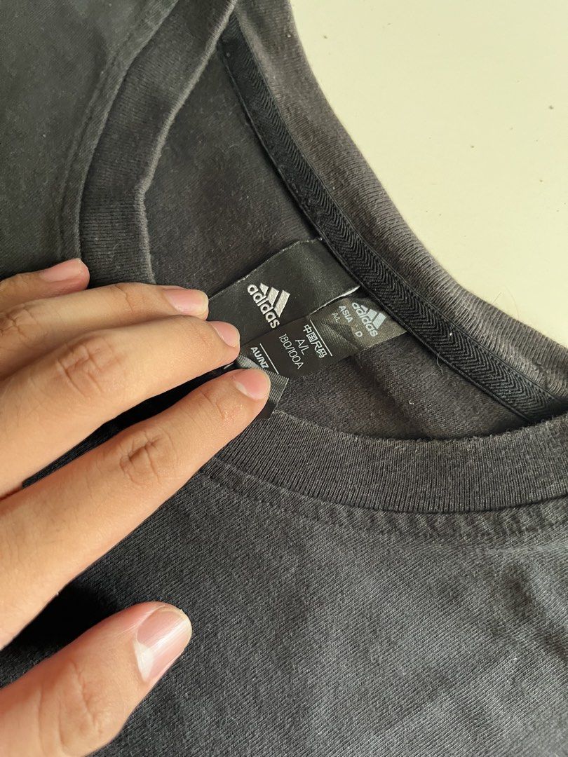 Adidas Simple Logo Black Shirt (Category: Activewear) located in Santa Ana. Submitted by rlave (Listing ID 1449875685, Image 3). Description: Preloved Adidas black shirt, featuring a small embroidered logo on the chest, sourced from a trusted supplier. Simple, versatile design great for everyday casual wear or layering. Item is in good preloved condition (see photos for actual item, including close-ups of the logo and tags). Grab it while it last