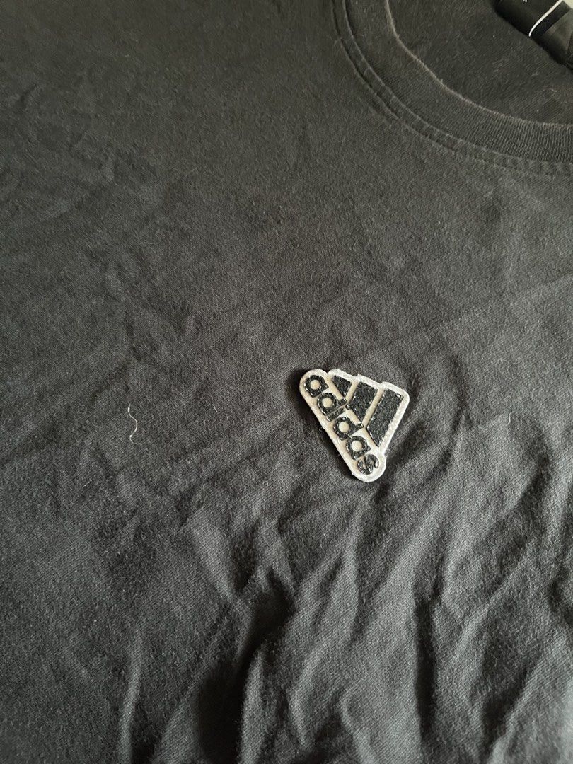 Adidas Simple Logo Black Shirt (Category: Activewear) located in Santa Ana. Submitted by rlave (Listing ID 1449875685, Image 2). Description: Preloved Adidas black shirt, featuring a small embroidered logo on the chest, sourced from a trusted supplier. Simple, versatile design great for everyday casual wear or layering. Item is in good preloved condition (see photos for actual item, including close-ups of the logo and tags). Grab it while it last