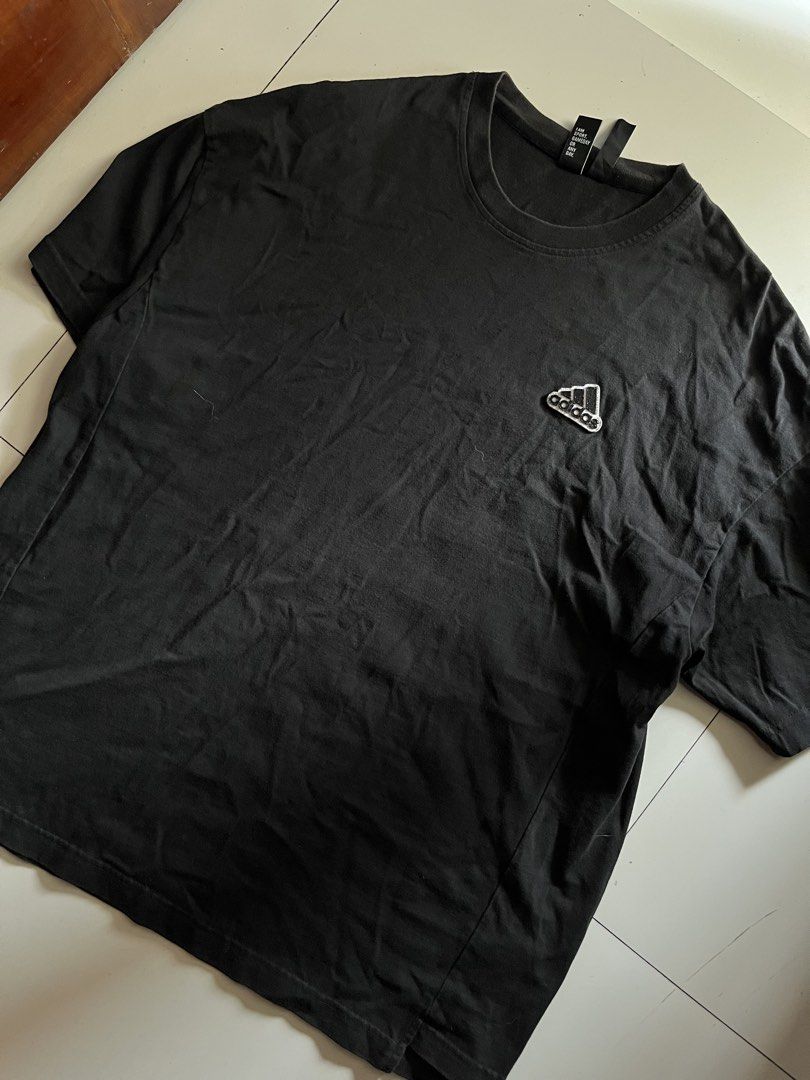 Adidas Simple Logo Black Shirt (Category: Activewear) located in Santa Ana. Submitted by rlave (Listing ID 1449875685, Image 1). Description: Preloved Adidas black shirt, featuring a small embroidered logo on the chest, sourced from a trusted supplier. Simple, versatile design great for everyday casual wear or layering. Item is in good preloved condition (see photos for actual item, including close-ups of the logo and tags). Grab it while it last