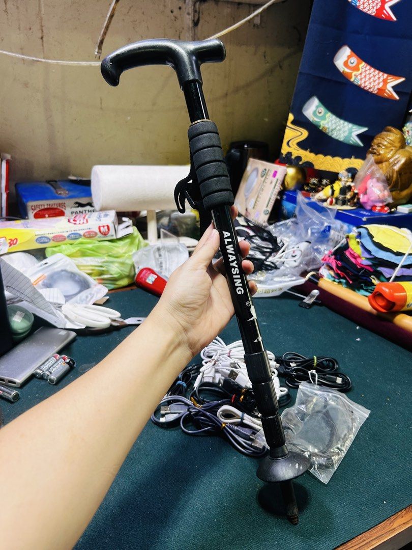 ALWAYSING Adjustable Folding Walking Cane (Category: Medical Supplies & Tools) located in Manila. Submitted by starbalesukandjapansurplus (Listing ID 1449832465, Image 2). Description: - Adjustable and foldable walking cane - Sleek black color - Comfortable grip handle - Includes a convenient strap - Features a durable rubber tip for stability - Easy to carry and transport - Provides excellent support for walking.