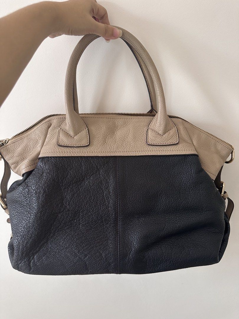 Anthem Two-Tone Leather Tote Bag (Category: Tote Bags) located in Antipolo. Submitted by waco1313 (Listing ID 1449788737, Image 3). Description: - Stylish black and beige leather Anthem handbag - Contrasting beige top handles - Secure zip closure for the main compartment - Convenient exterior zip pocket - Elegant gold hardware details - Ample interior space for everyday essentials - Ideal for daily use.