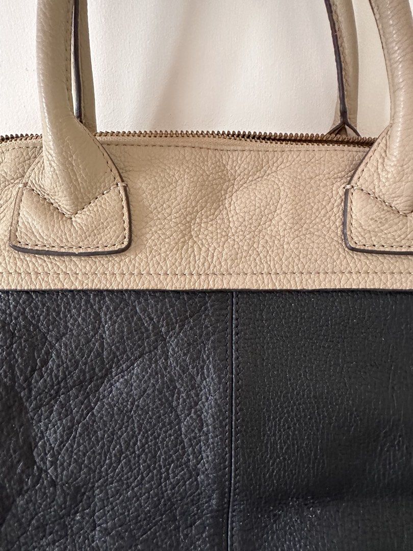 Anthem Two-Tone Leather Tote Bag (Category: Tote Bags) located in Antipolo. Submitted by waco1313 (Listing ID 1449788737, Image 2). Description: - Stylish black and beige leather Anthem handbag - Contrasting beige top handles - Secure zip closure for the main compartment - Convenient exterior zip pocket - Elegant gold hardware details - Ample interior space for everyday essentials - Ideal for daily use.