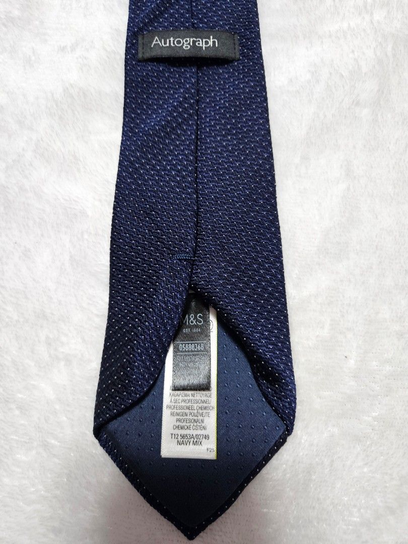 Autograph M&S Navy Blue Textured Silk Tie (Category: Ties) located in Caloocan City. Submitted by rm.diaz (Listing ID 1449759036, Image 2). Description: - Navy blue tie from Autograph by Marks & Spencer - Features a textured pattern all over - Crafted from a silk and wool blend - Ideal for formal occasions or to smarten up any outfit - Classic and timeless design.