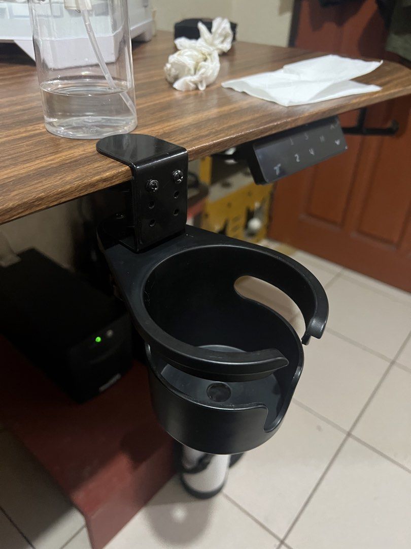 Black Metal Desk Clamp Cup Holder (Category: Home Improvement Tools & Accessories) located in Baguio. Submitted by ashilily (Listing ID 1449853886, Image 2). Description: - Mounts securely to your desk edge. - Holds cups or bottles within easy reach. - Durable black metal construction. - Simple and easy installation with a clamp. - Perfect for gaming setups and office desks. - Prevents accidental spills on your keyboard and workspace..