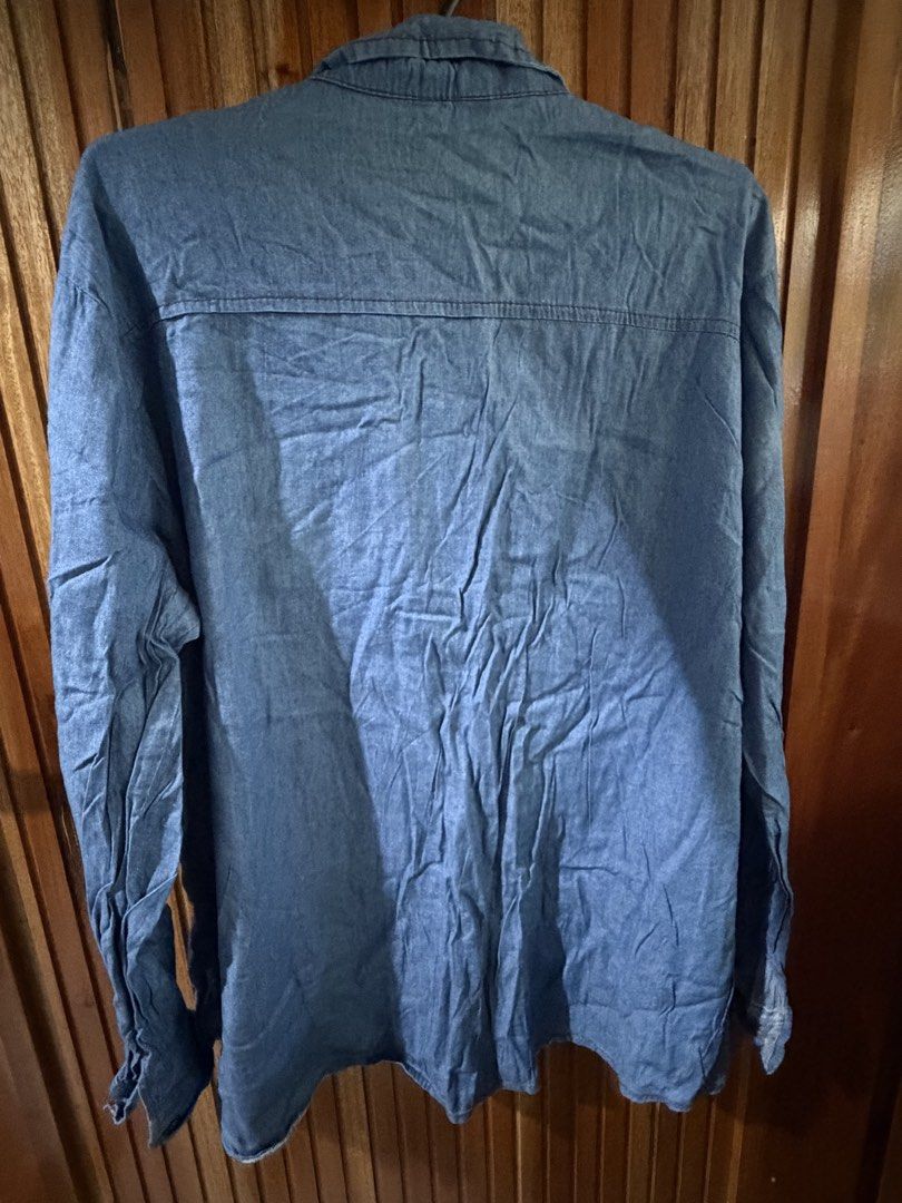 Blue Denim Long Sleeve Shirt (Category: Longsleeves) located in San Jose del Monte. Submitted by dcrishop (Listing ID 1449768392, Image 2). Description: - Classic blue denim shirt - Long sleeves with button cuffs - Two chest pockets with button closures - Button-up front - Relaxed fit - Great for layering or wearing on its own.