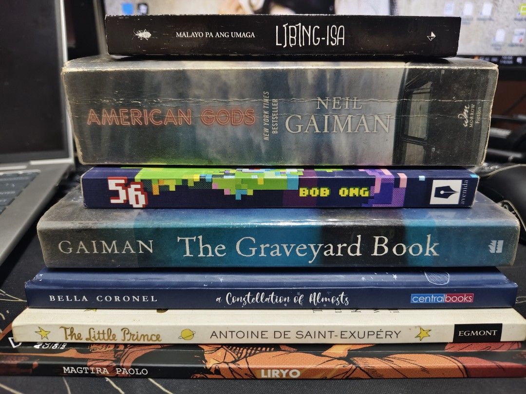 Books Bundle (Category: Storybooks) located in Caloocan City. Submitted by momosanamina (Listing ID 1449952039, Image 1). Description: Book bundle. 1. Libing-isa 2. American Gods by Neil Gaiman 3. 56 by Bob Ong 4. The Graveyard Book by Neil Gaiman 5. Constellation of Almosts by Bella Coronel 6. The Little Prince 7. Liryo .